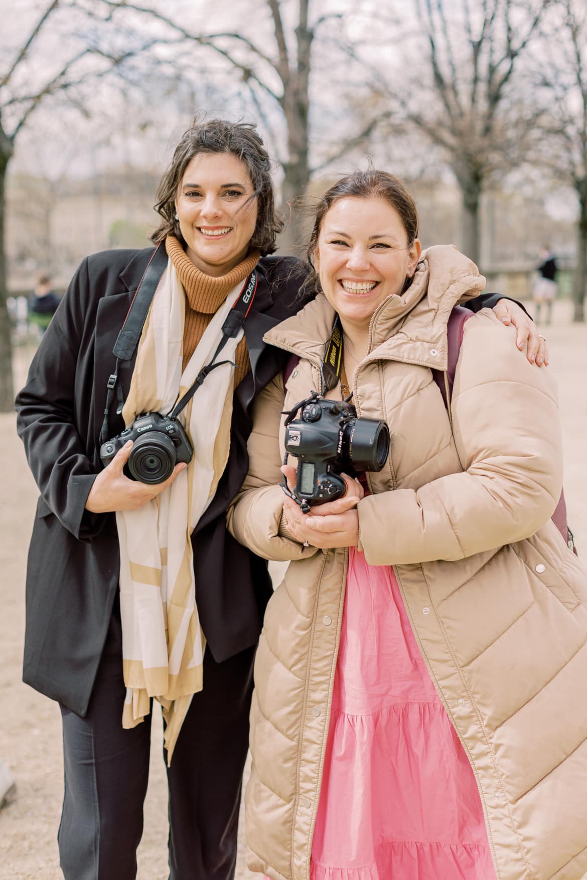Zwei Frauen mit Kameras lachen