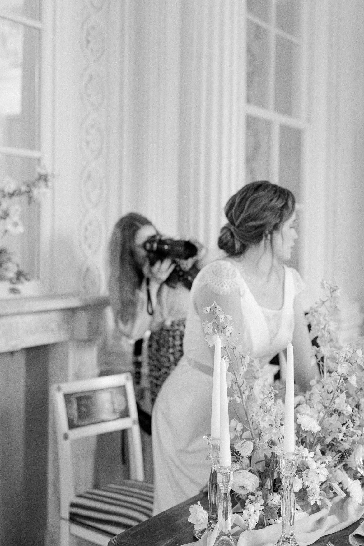 Fotografin fotografiert eine Braut an einem Tisch